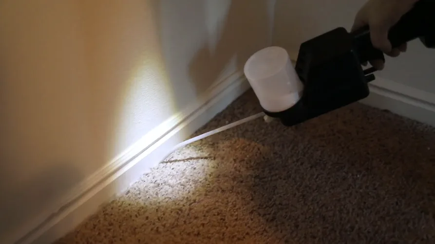 Rodent bait station placed along an interior baseboard run
