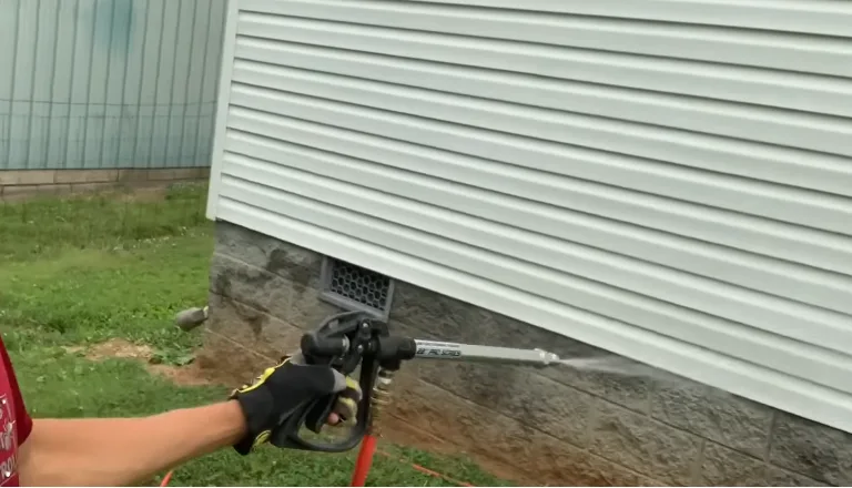 Treating behind a lifted section of vinyl siding where rodents can travel