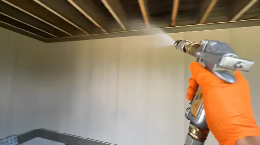 Spray applied along the underside of a soffit run